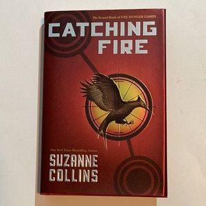 Book, “Catching Fire” by Suzanne Collins, Second book of the Hunger Games